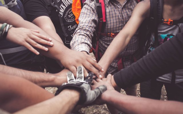Handles of multiple ethnicities huddled together in the circle
